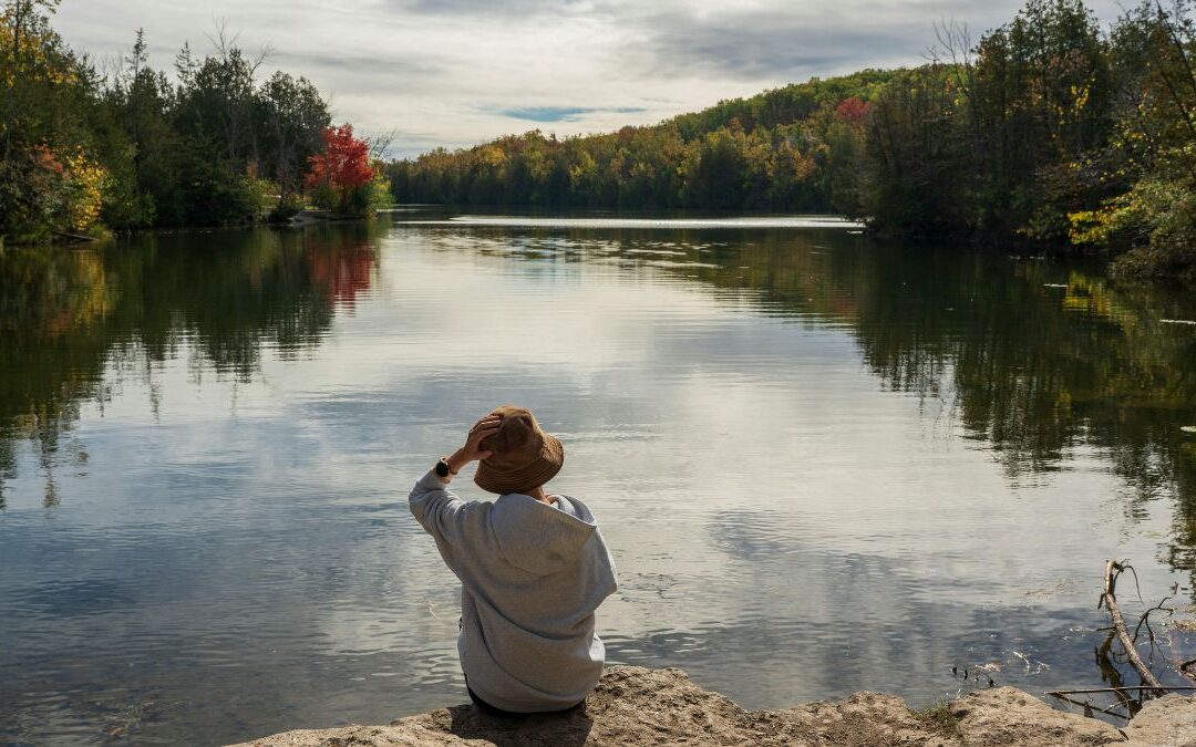 Reflective woman by a lake