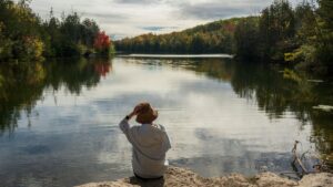 Reflective woman by a lake