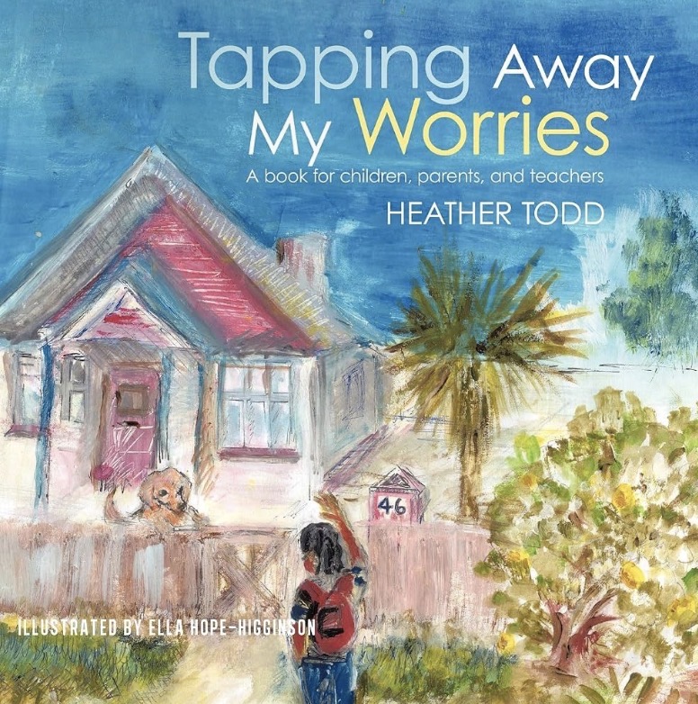 Author Heather Todd holding a children's book she wrote, illustrating her commitment to supporting emotional growth in children.